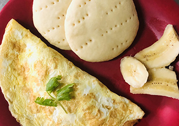 home-cooked meals are prepared with fresh ingredients.- cheese and ham egg omelette with Johnny cakes.